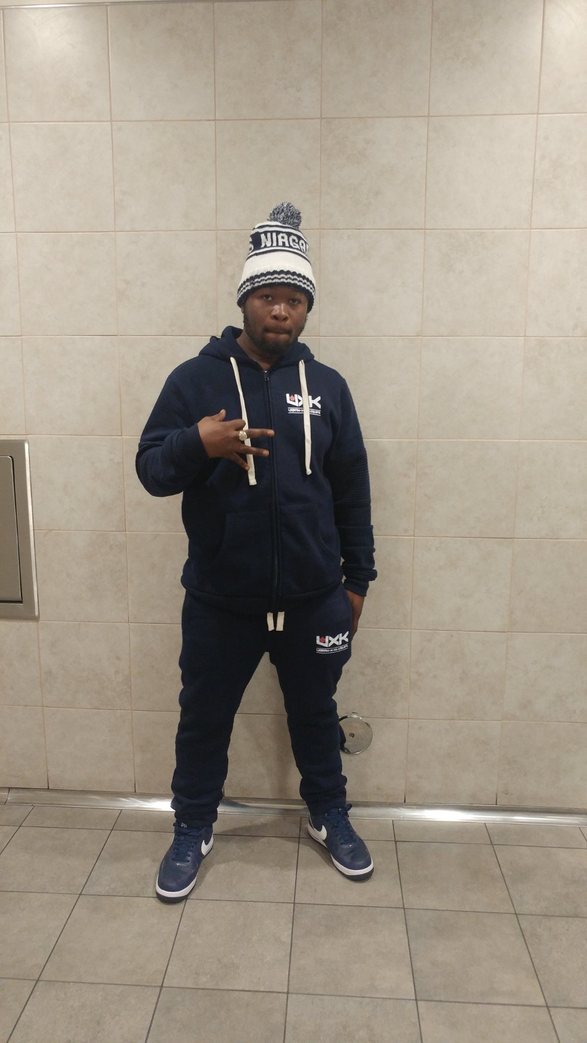 Trav in the navy UXK sweatsuit