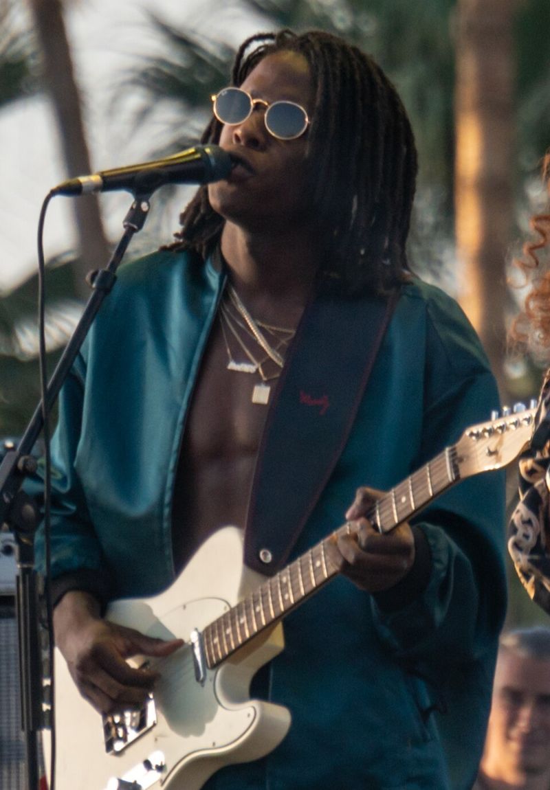 Daniel Caesar performing with guitar